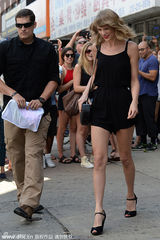 组图：斯威夫特黑色短裙秀长腿 腼腆出街笑不停