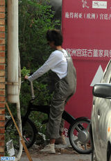 组图：张歆艺798独自骑车游玩 摘花折枝心情好