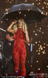 组图：Rita Ora撑黑伞演出 红色蕾丝连身裤秀身段